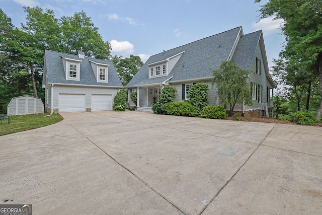 2216 Trammel Rd, Cumming, GA 30041 - view of front of house with a garage, a storage unit, driveway, and roof with shingles
