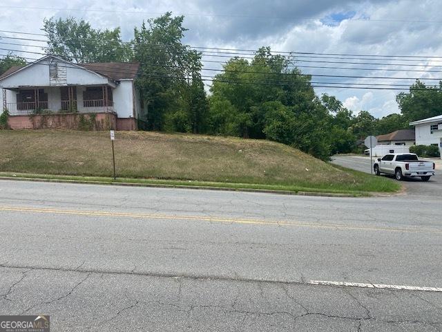 1010 N Clarke St, Milledgeville, GA 31061 - view of asphalt road with traffic signs and curbs