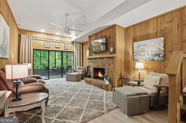 251 Shakespeare Dr Unit 332, Clayton, GA 30525 - living area featuring wood walls, a ceiling fan, a fireplace, and wood finished floors