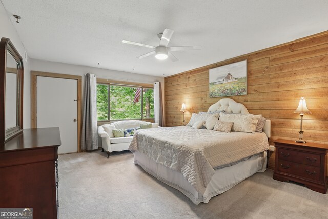 251 Shakespeare Dr Unit 332, Clayton, GA 30525 - bedroom featuring light carpet, wood walls, and a ceiling fan