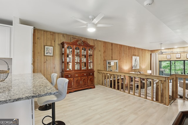 251 Shakespeare Dr Unit 332, Clayton, GA 30525 - dining room with wood walls, a ceiling fan, and light wood-style flooring