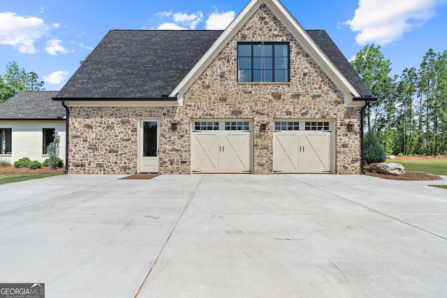 5700 Goolsby Rd, Monticello, GA 31064 - view of property exterior with concrete driveway, stone siding, and a garage