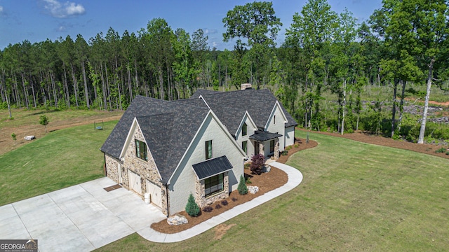 5700 Goolsby Rd, Monticello, GA 31064 - view of front of property featuring stone siding, driveway, a front lawn, a standing seam roof, and a chimney
