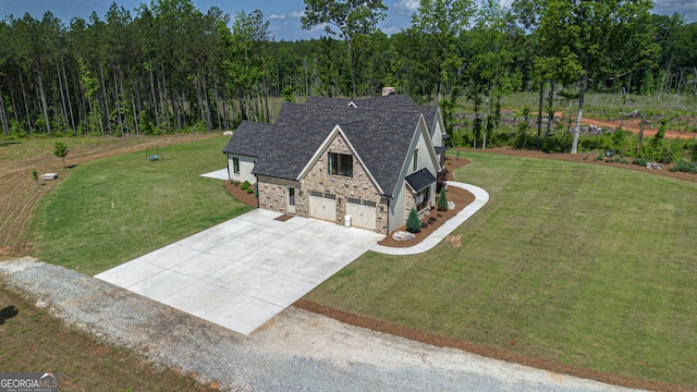 5700 Goolsby Rd, Monticello, GA 31064 - view of front of home with driveway, stone siding, a front lawn, a garage, and roof with shingles