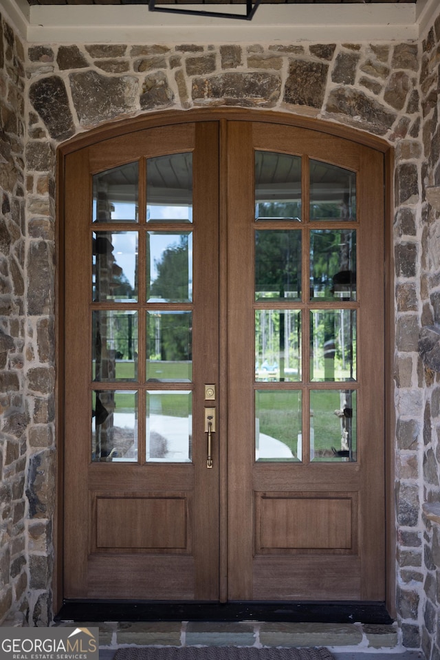 5700 Goolsby Rd, Monticello, GA 31064 - view of exterior entry featuring stone siding and french doors
