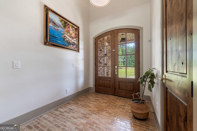 5700 Goolsby Rd, Monticello, GA 31064 - entryway with arched walkways, brick flooring, baseboards, and french doors