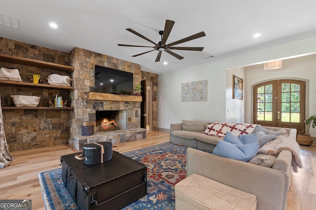 5700 Goolsby Rd, Monticello, GA 31064 - living area featuring wood finished floors, ceiling fan, recessed lighting, french doors, and a stone fireplace