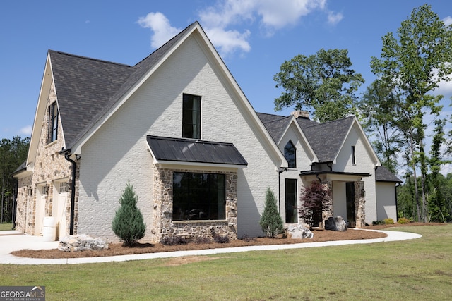5700 Goolsby Rd, Monticello, GA 31064 - view of front of home featuring a front lawn, a chimney, roof with shingles, and brick siding