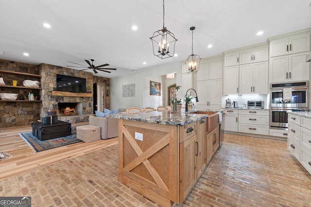 5700 Goolsby Rd, Monticello, GA 31064 - kitchen featuring ceiling fan, stainless steel double oven, a sink, brick flooring, and recessed lighting