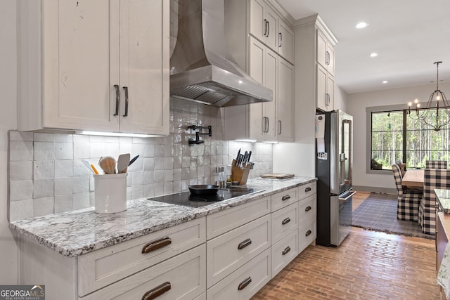 5700 Goolsby Rd, Monticello, GA 31064 - kitchen featuring extractor fan, freestanding refrigerator, black electric stovetop, white cabinets, and recessed lighting