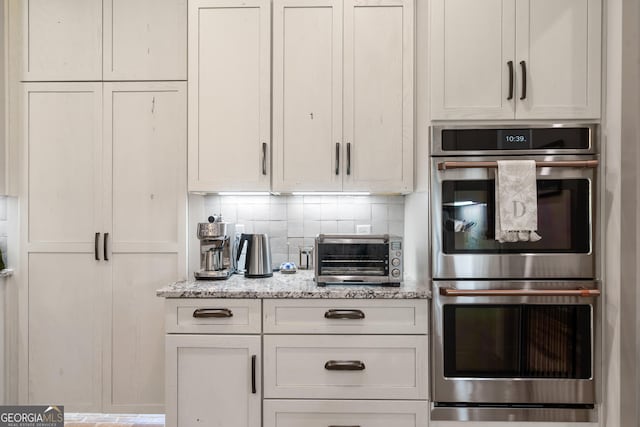 5700 Goolsby Rd, Monticello, GA 31064 - kitchen featuring double oven, tasteful backsplash, and light stone counters