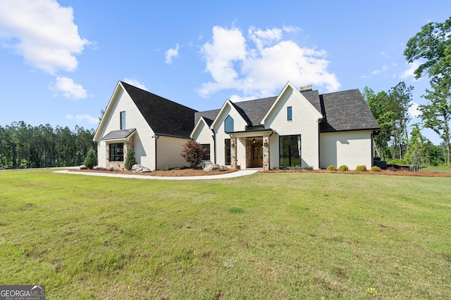 5700 Goolsby Rd, Monticello, GA 31064 - modern farmhouse with a front lawn, a chimney, and brick siding