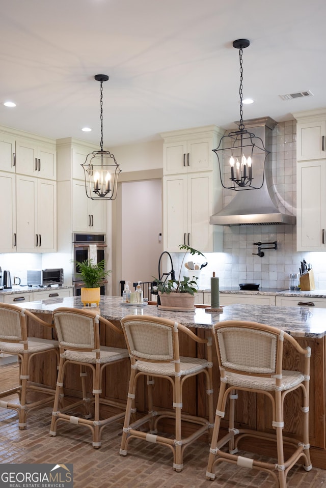5700 Goolsby Rd, Monticello, GA 31064 - kitchen with a chandelier, stainless steel oven, backsplash, custom exhaust hood, and recessed lighting