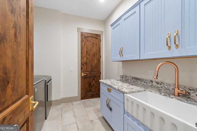 5700 Goolsby Rd, Monticello, GA 31064 - washroom with cabinet space, washing machine and dryer, and light stone finish floors