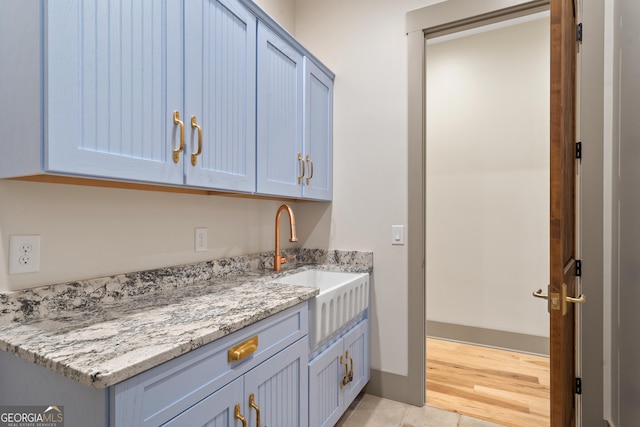 5700 Goolsby Rd, Monticello, GA 31064 - kitchen with a sink, light stone counters, and light tile patterned floors