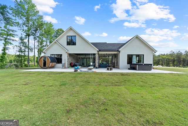 5700 Goolsby Rd, Monticello, GA 31064 - back of property with a hot tub, a patio area, brick siding, and a yard