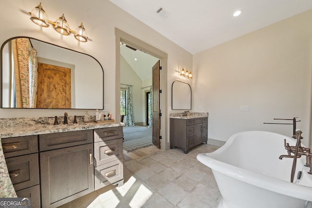 5700 Goolsby Rd, Monticello, GA 31064 - full bath featuring two vanities, a freestanding tub, recessed lighting, and lofted ceiling