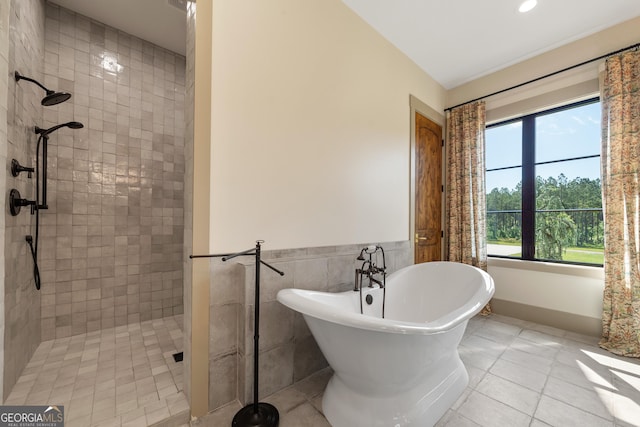 5700 Goolsby Rd, Monticello, GA 31064 - full bath featuring a tile shower, a freestanding tub, tile walls, tile patterned floors, and a wainscoted wall