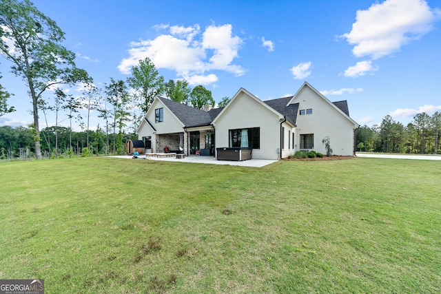 5700 Goolsby Rd, Monticello, GA 31064 - back of house featuring a patio, a hot tub, and a lawn