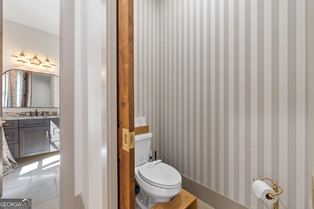 5700 Goolsby Rd, Monticello, GA 31064 - bathroom featuring toilet, vanity, wallpapered walls, and tile patterned flooring