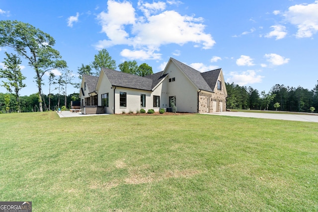 5700 Goolsby Rd, Monticello, GA 31064 - view of front of house with concrete driveway, a front lawn, an attached garage, and a covered hot tub