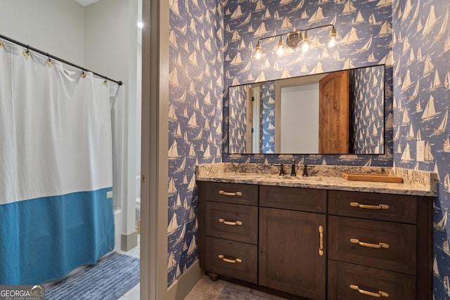 5700 Goolsby Rd, Monticello, GA 31064 - full bathroom with wallpapered walls, vanity, toilet, and a shower with shower curtain