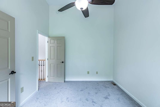 235 Red Bud Ln Unit 5, Hiawassee, GA 30546 - unfurnished bedroom with carpet flooring, baseboards, a ceiling fan, and a high ceiling