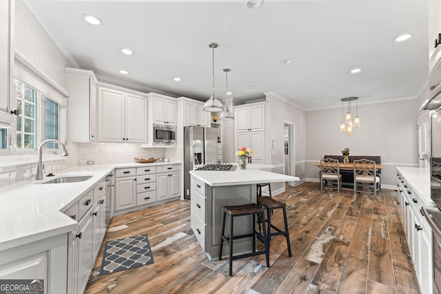 4030 River Ridge Chase Se, Marietta, GA 30067 - kitchen with a sink, stainless steel appliances, crown molding, a breakfast bar area, and tasteful backsplash