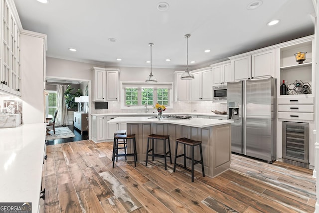4030 River Ridge Chase Se, Marietta, GA 30067 - kitchen featuring stainless steel appliances, wine cooler, a center island, white cabinets, and a breakfast bar