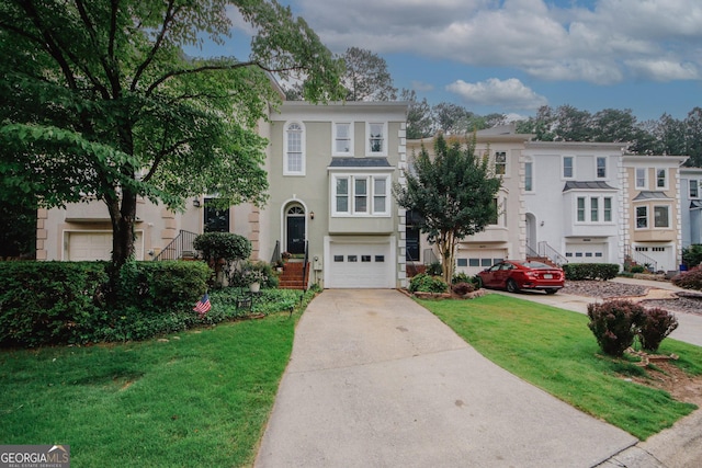 3697 E Bay St, Duluth, GA 30096 - multi unit property featuring driveway, a garage, a front yard, and stucco siding
