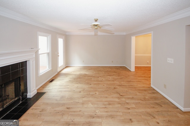 3697 E Bay St, Duluth, GA 30096 - unfurnished living room featuring a tile fireplace, ornamental molding, a ceiling fan, wood finished floors, and baseboards