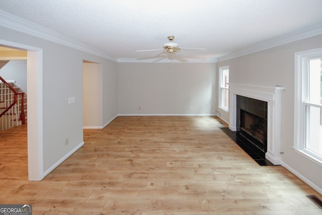 3697 E Bay St, Duluth, GA 30096 - unfurnished living room featuring ceiling fan, a fireplace, healthy amount of natural light, and ornamental molding