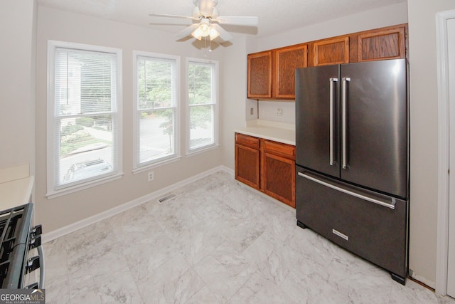 3697 E Bay St, Duluth, GA 30096 - kitchen with appliances with stainless steel finishes, brown cabinets, ceiling fan, and light marble finish floors