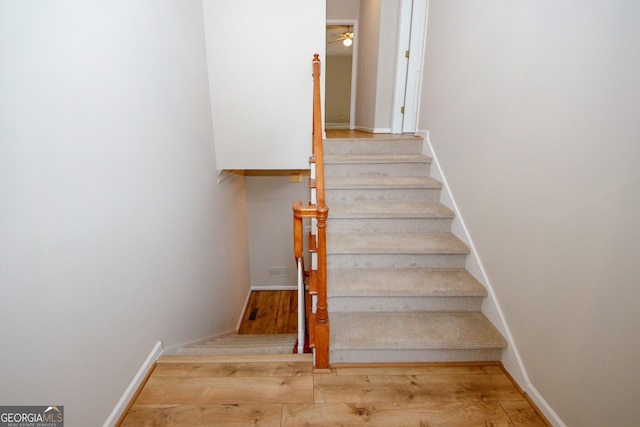 3697 E Bay St, Duluth, GA 30096 - stairs featuring a ceiling fan, wood finished floors, and baseboards
