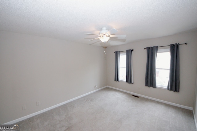 3697 E Bay St, Duluth, GA 30096 - spare room featuring a ceiling fan, a textured ceiling, light carpet, and baseboards