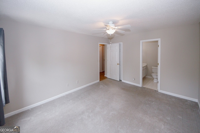 3697 E Bay St, Duluth, GA 30096 - unfurnished bedroom with carpet, baseboards, ensuite bathroom, and ceiling fan