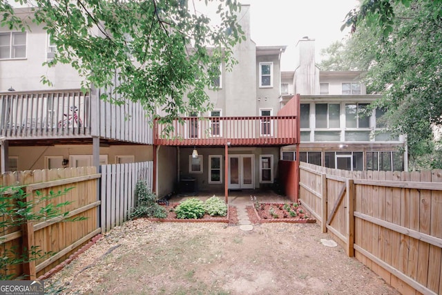 3697 E Bay St, Duluth, GA 30096 - back of house with french doors, a fenced backyard, stucco siding, and a chimney