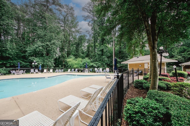 3697 E Bay St, Duluth, GA 30096 - community pool with a patio area and view of wooded area