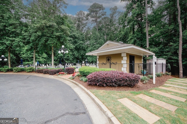3697 E Bay St, Duluth, GA 30096 - view of asphalt street with curbs, street lights, and view of wooded area