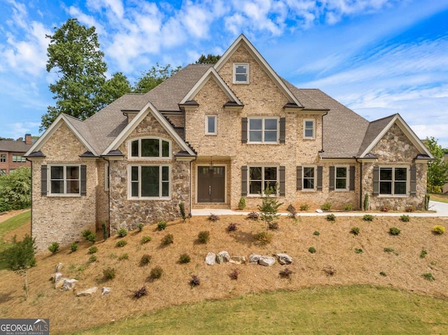 4821 Deer Creek Ct, Flowery Branch, GA 30542 - craftsman-style house with a shingled roof, stone siding, and a front lawn