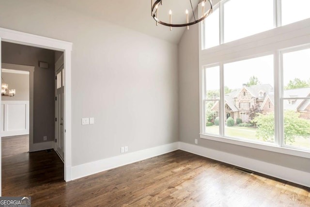 4821 Deer Creek Ct, Flowery Branch, GA 30542 - spare room with a chandelier, plenty of natural light, dark wood-style flooring, and high vaulted ceiling