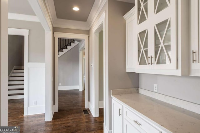 4821 Deer Creek Ct, Flowery Branch, GA 30542 - bar area with stairway, dark wood-style flooring, and crown molding