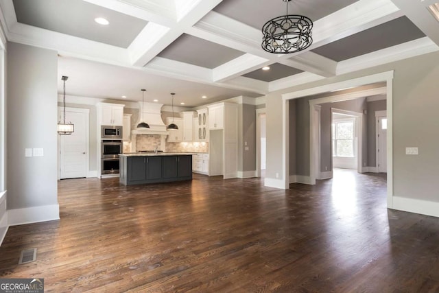 4821 Deer Creek Ct, Flowery Branch, GA 30542 - unfurnished living room with a chandelier, coffered ceiling, beamed ceiling, dark wood-type flooring, and recessed lighting