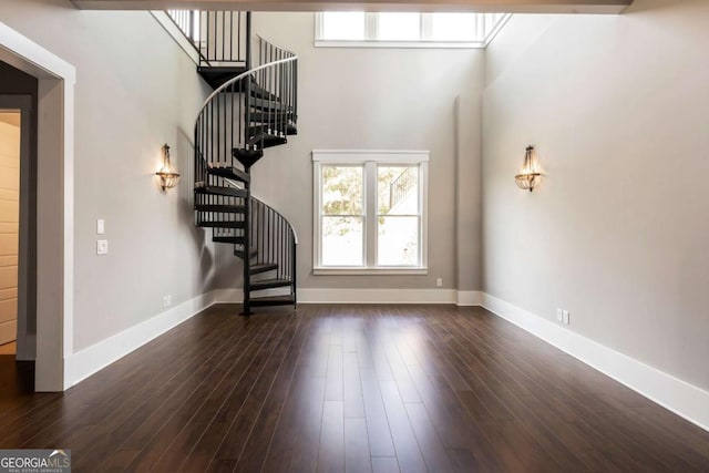 4821 Deer Creek Ct, Flowery Branch, GA 30542 - unfurnished living room featuring stairway, dark wood-style flooring, and a high ceiling
