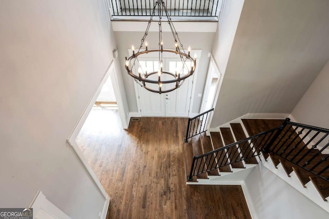 4821 Deer Creek Ct, Flowery Branch, GA 30542 - stairway with a high ceiling, wood finished floors, and a chandelier