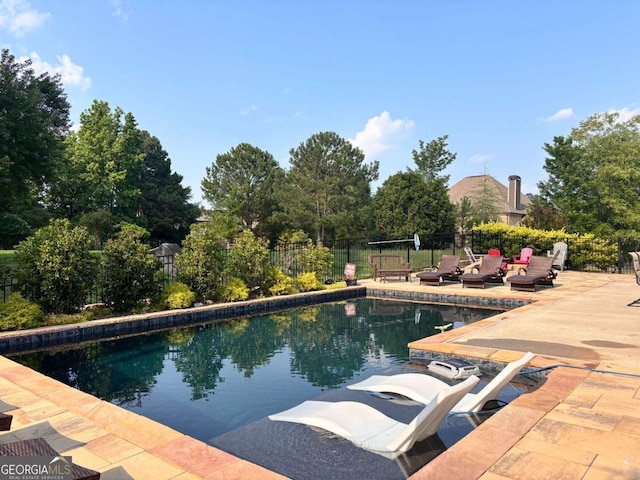 4821 Deer Creek Ct, Flowery Branch, GA 30542 - view of swimming pool with a patio area and view of wooded area