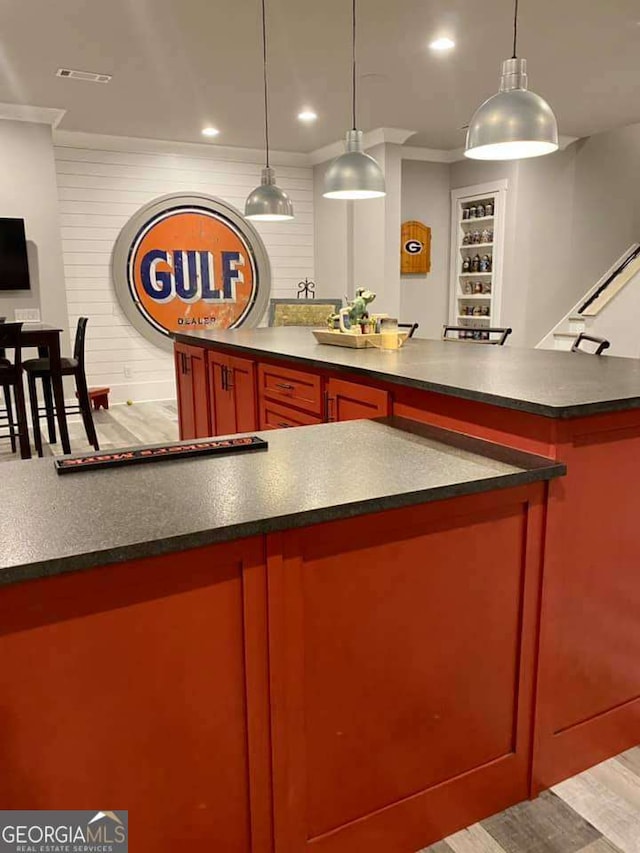 4821 Deer Creek Ct, Flowery Branch, GA 30542 - kitchen with dark countertops, ornamental molding, decorative light fixtures, recessed lighting, and reddish brown cabinets