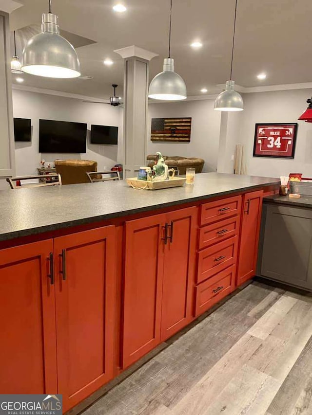 4821 Deer Creek Ct, Flowery Branch, GA 30542 - kitchen with ornamental molding, light wood finished floors, open floor plan, dark countertops, and decorative light fixtures