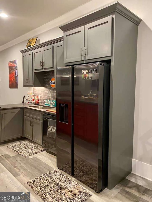 4821 Deer Creek Ct, Flowery Branch, GA 30542 - kitchen featuring stainless steel refrigerator with ice dispenser, dishwasher, light wood finished floors, tasteful backsplash, and crown molding