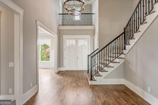 4821 Deer Creek Ct, Flowery Branch, GA 30542 - foyer entrance featuring a high ceiling, stairs, a chandelier, and wood finished floors